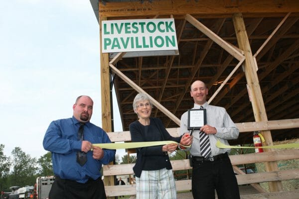 Executive member, Local MPP Julia Munro and 2013 Sutton Fair President Steve Cowieson cut the ribbon to officially open the Livestock Pavillion
